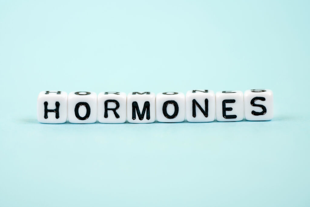 White blocks that spell out the word “HORMONES”