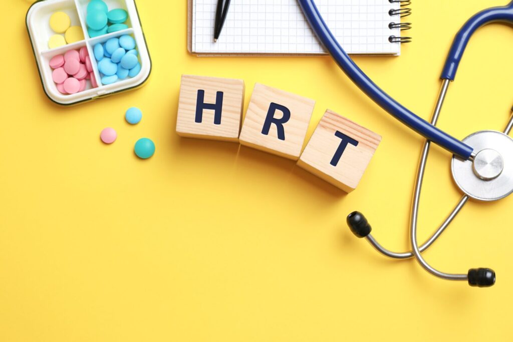 Wooden,Cubes,With,Abbreviation,Hrt,,Pills,,Stethoscope,And,Notebook,On